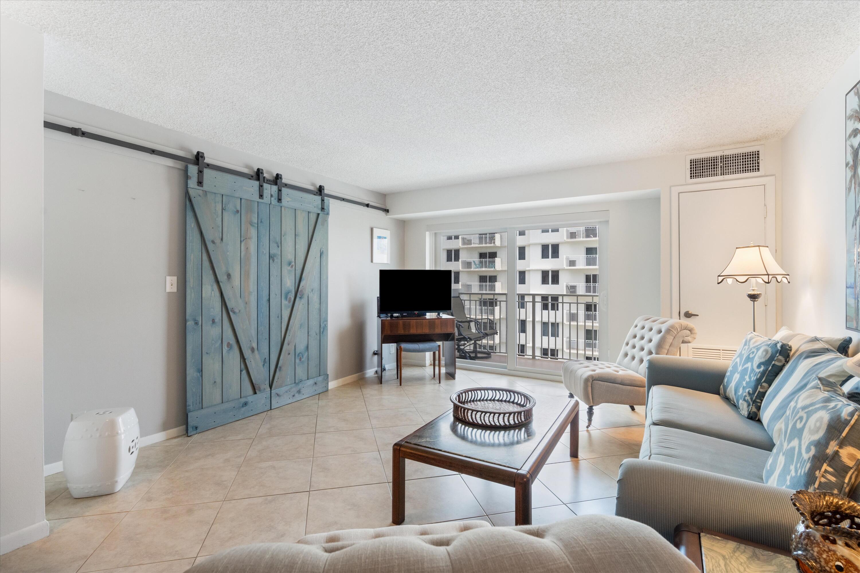 3301 South Ocean Boulevard, Unit 808 Highland Beach, FL 33487 - Photo 19 of 33 a living room with furniture and a flat screen tv