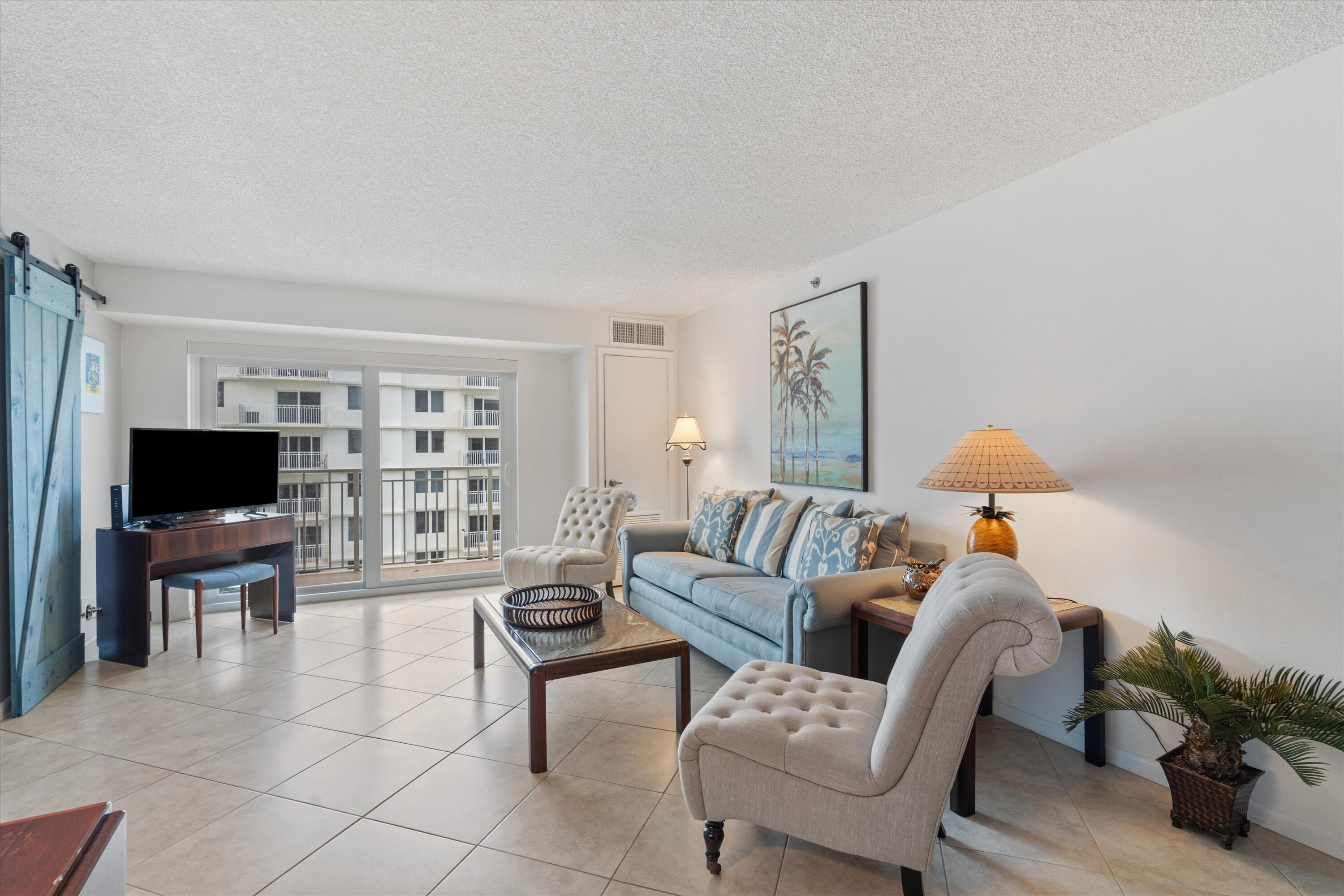 3301 South Ocean Boulevard, Unit 808 Highland Beach, FL 33487 - Photo 21 of 33 a living room with furniture and a flat screen tv