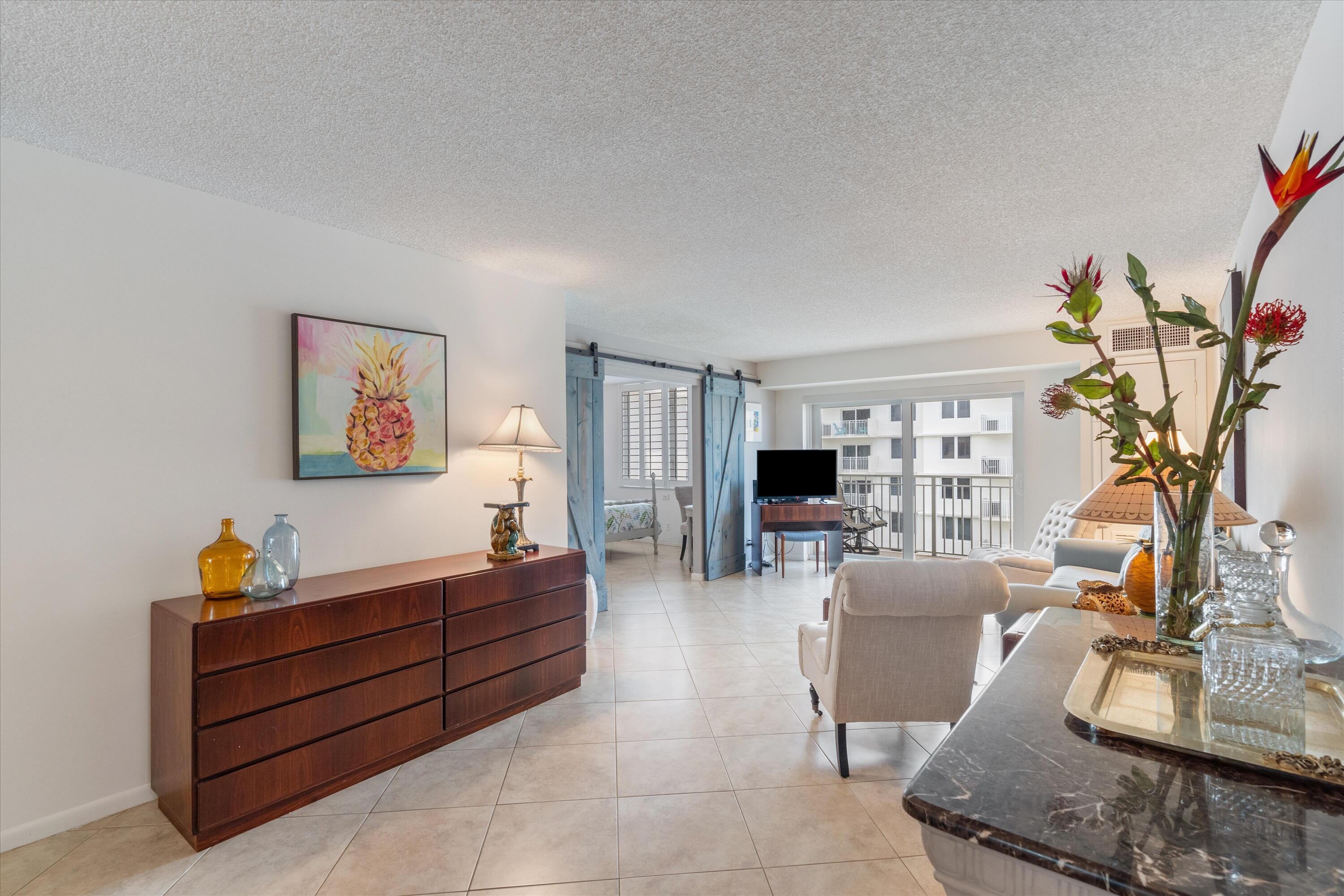 3301 South Ocean Boulevard, Unit 808 Highland Beach, FL 33487 - Photo 22 of 33 a living room with furniture and a flat screen tv