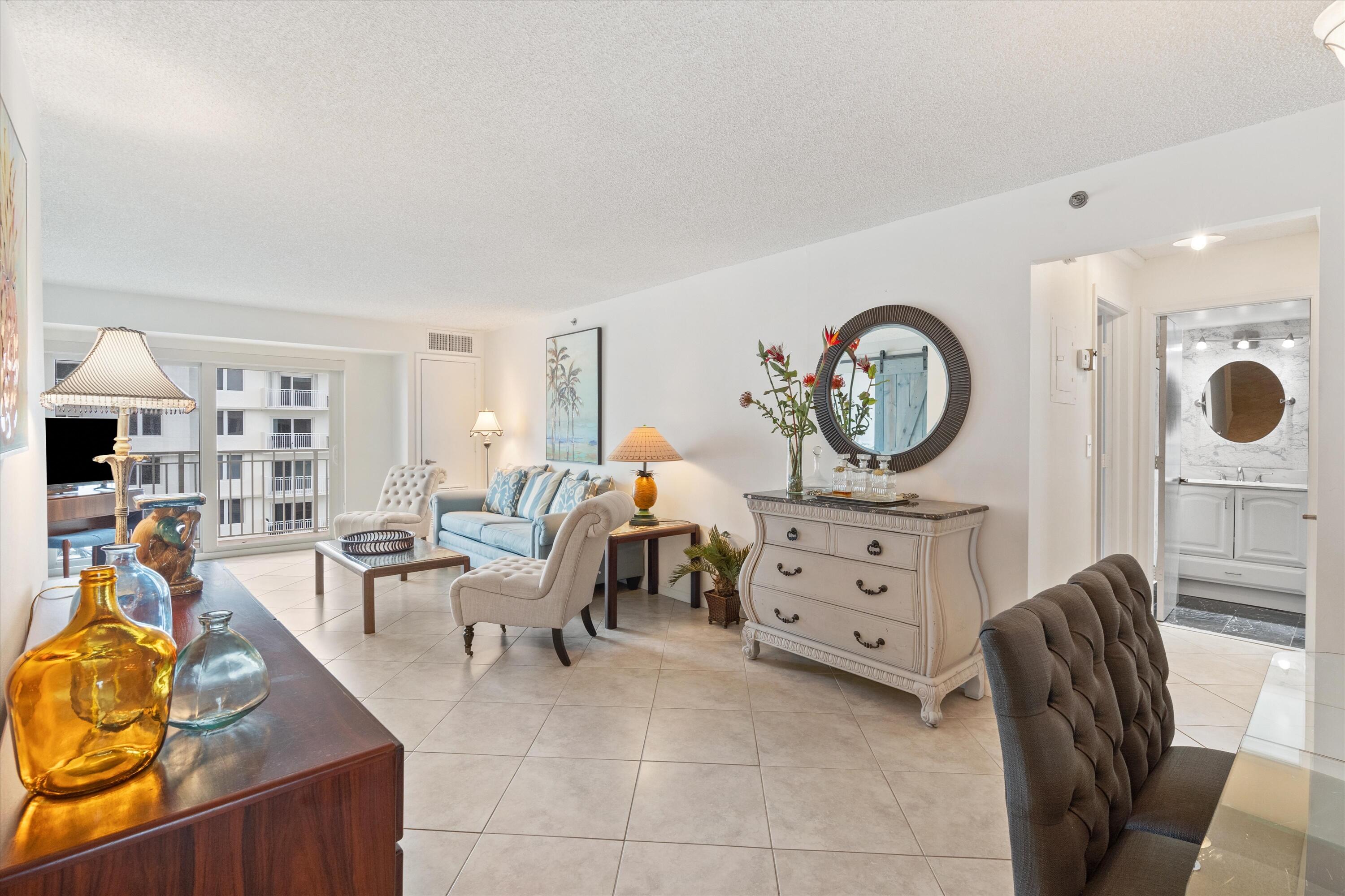 3301 South Ocean Boulevard, Unit 808 Highland Beach, FL 33487 - Photo 7 of 33 a living room with furniture a dining table chairs and a stove top oven