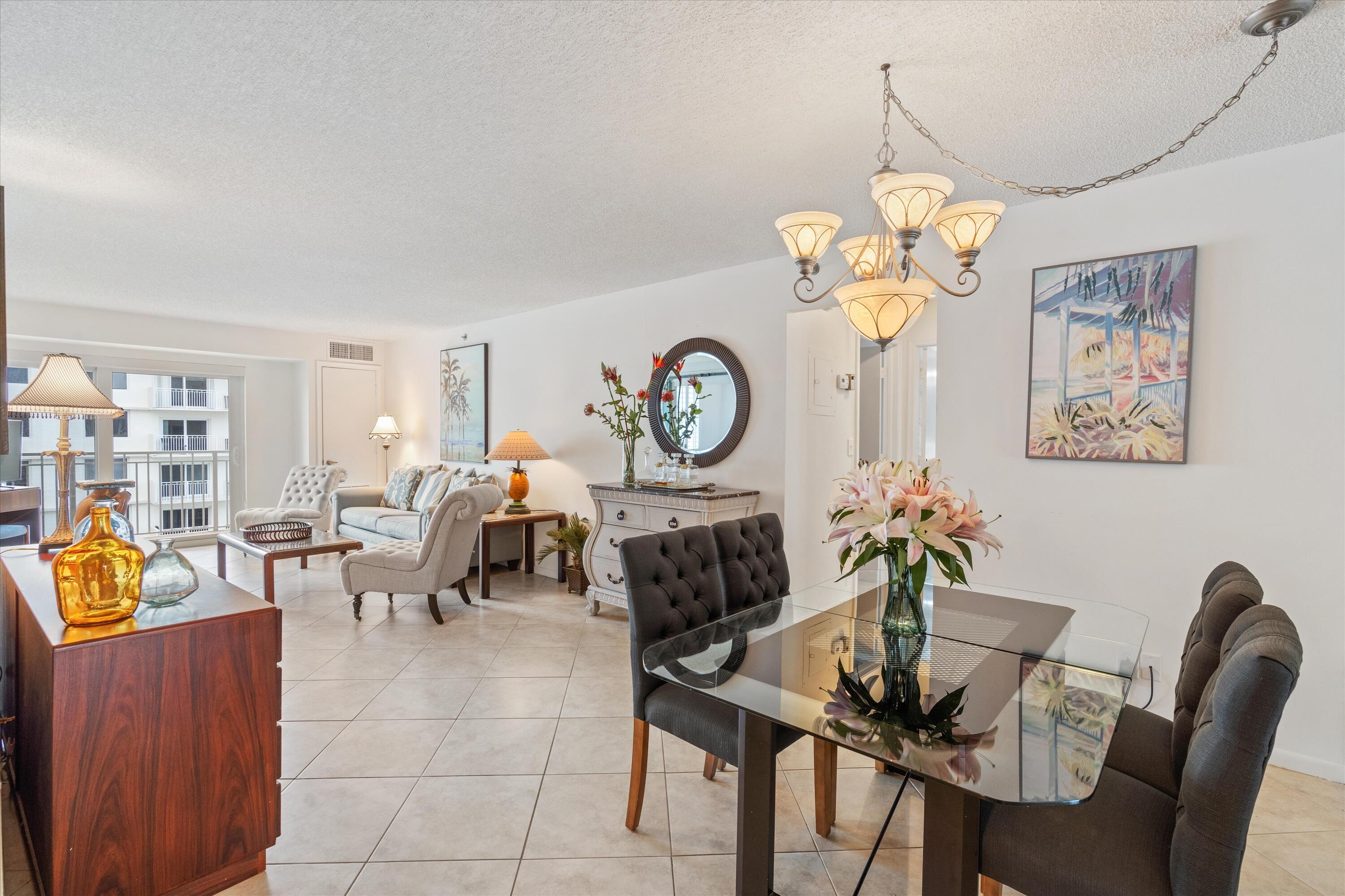 3301 South Ocean Boulevard, Unit 808 Highland Beach, FL 33487 - Photo 8 of 33 a living room filled with furniture dining table and a chandelier
