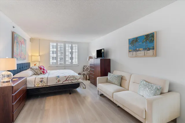 a bedroom with a bed and a television