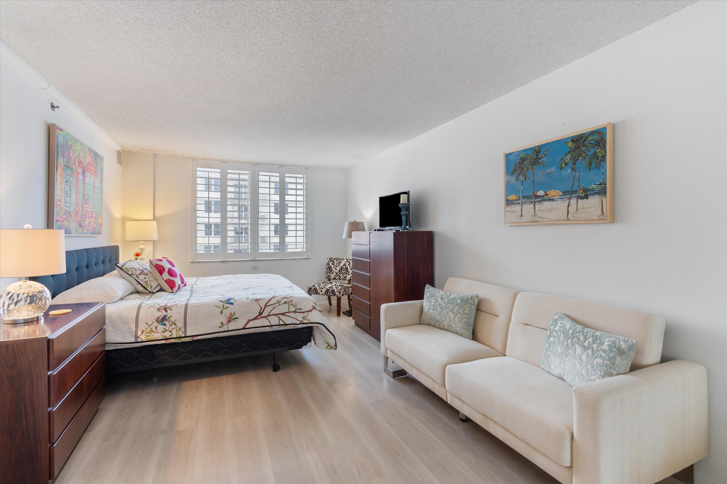 3301 South Ocean Boulevard, Unit 808 Highland Beach, FL 33487 - Photo 9 of 33 a bed room with bed and a couch