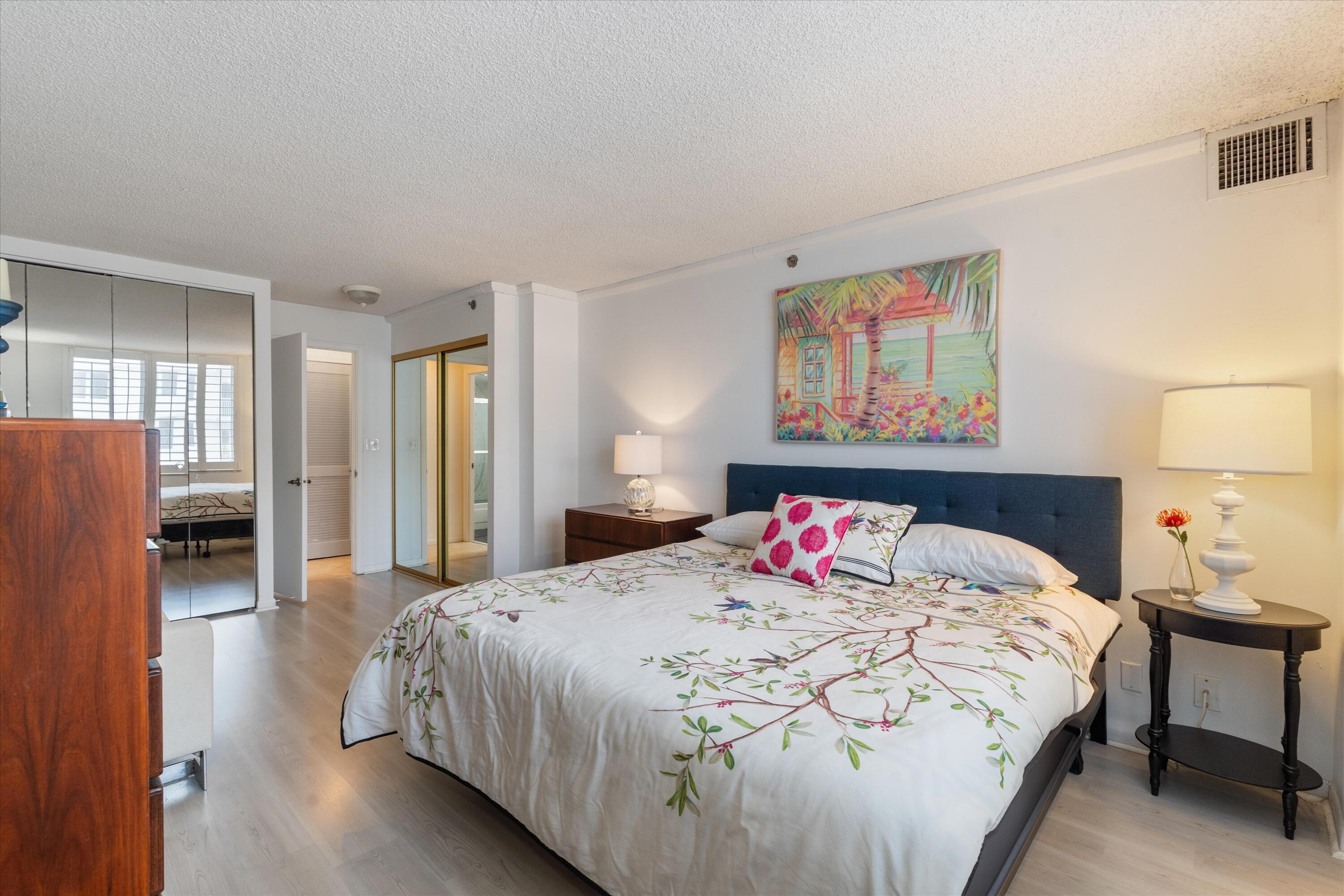 3301 South Ocean Boulevard, Unit 808 Highland Beach, FL 33487 - Photo 10 of 33 a bedroom with a bed and a painting on the wall