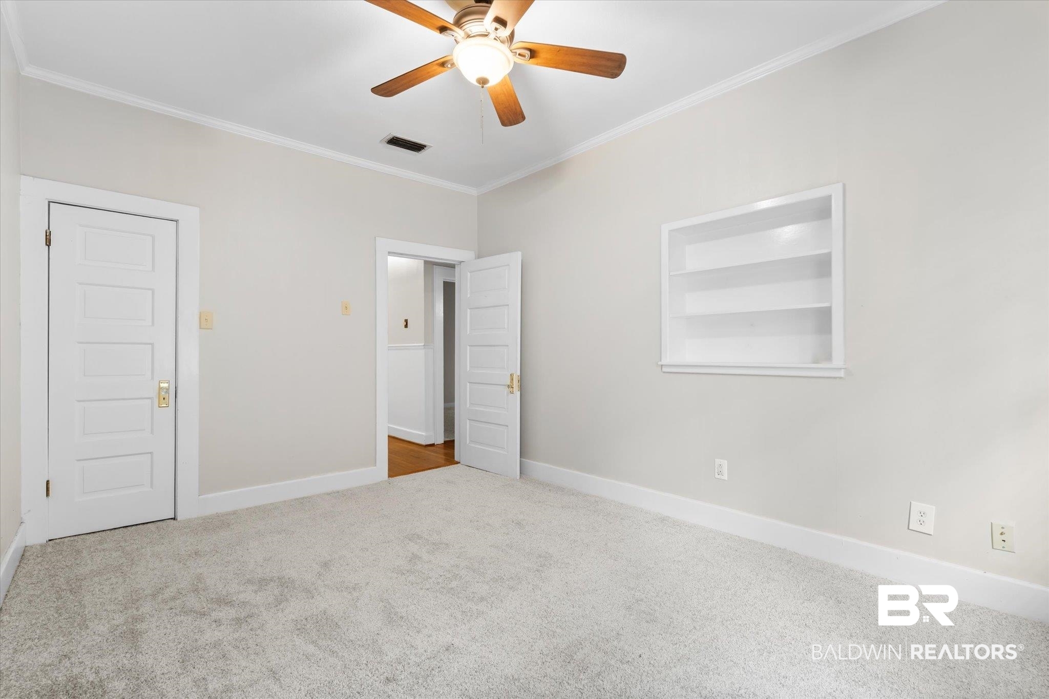 211 3rd Street Mobile, AL 36611 - Photo 16 of 20 Unfurnished bedroom featuring ceiling fan, carpet floors, and crown molding