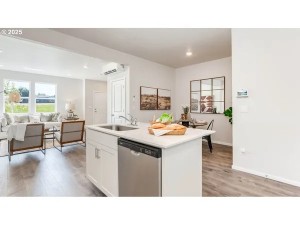 a kitchen with a sink cabinets and wooden floor