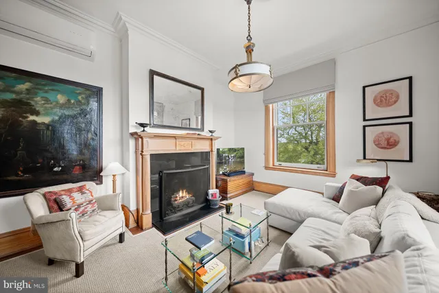 a living room with furniture a window and a fireplace