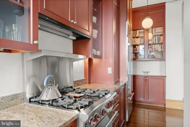 a kitchen with granite countertop a stove and a sink