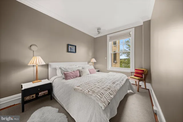 a bedroom with a bed and a lamp on table