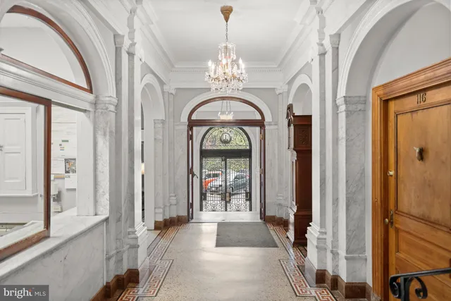 a view of a entryway door and chandelier