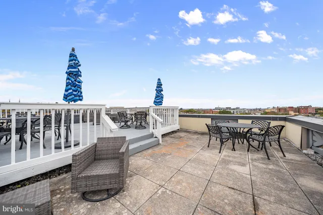 a view of a terrace with chairs and a table