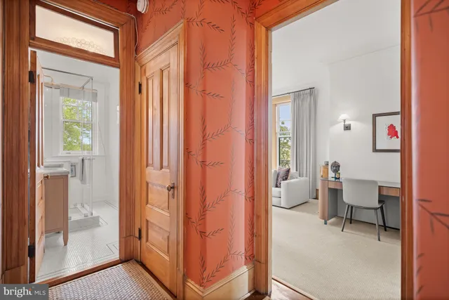 a view of a hallway with furniture and a livingroom view