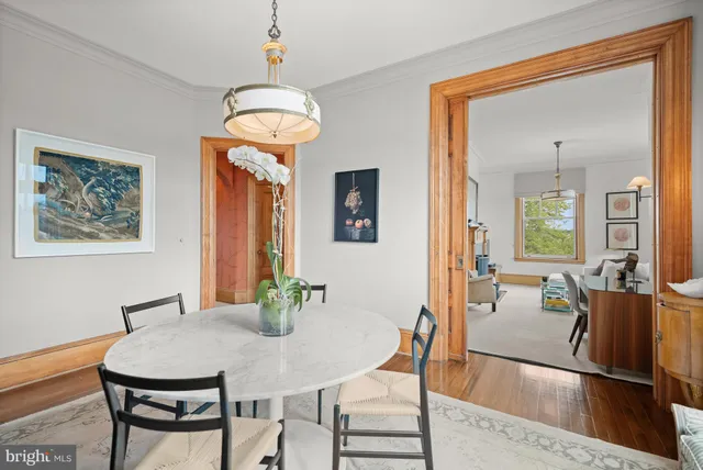 a view of a dining room with furniture and a chandelier