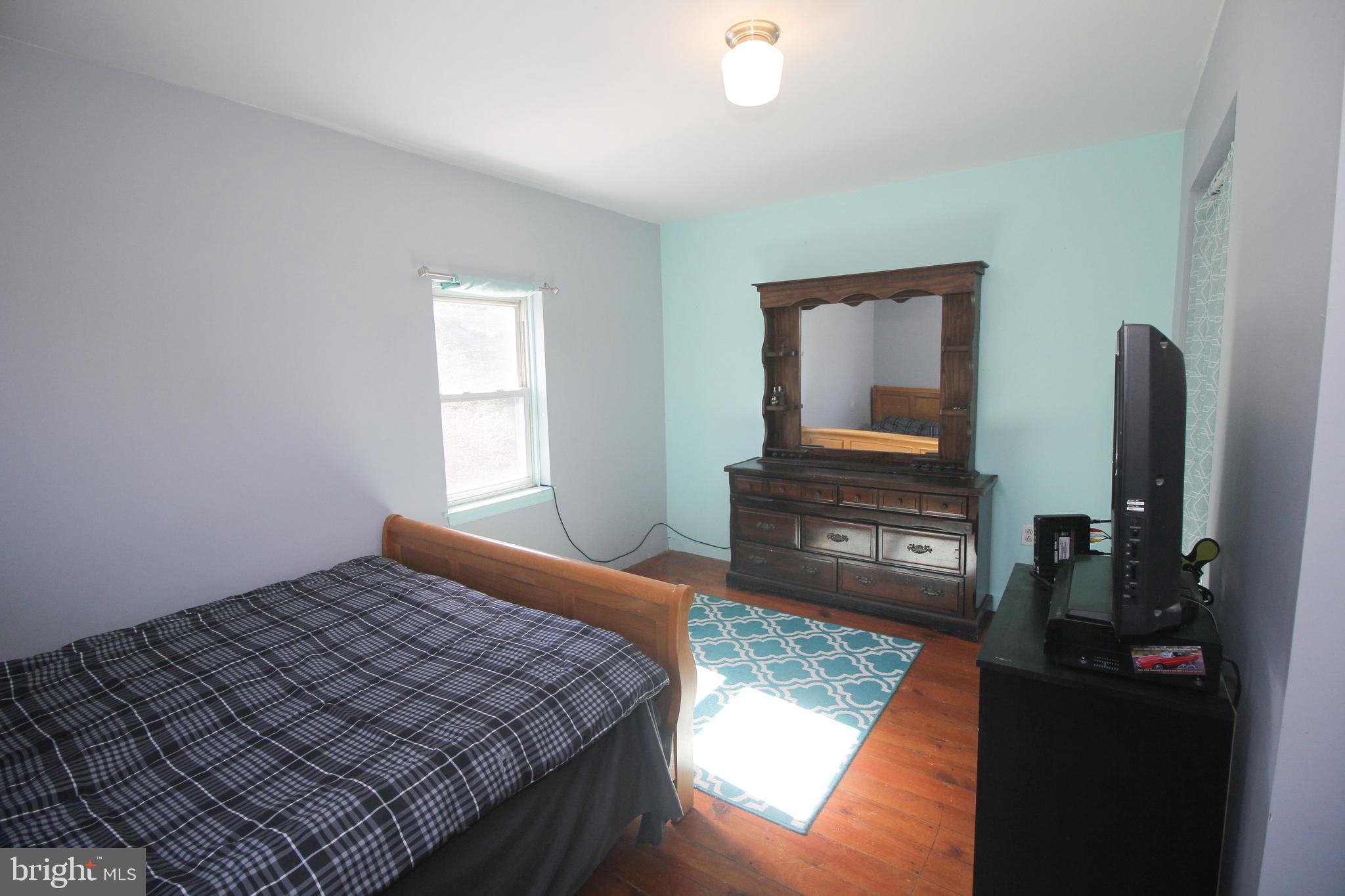 160 Funk Road Port Deposit, MD 21904 - Photo 35 of 51 a bedroom with a bed dresser and a flat tv screen on a dresser