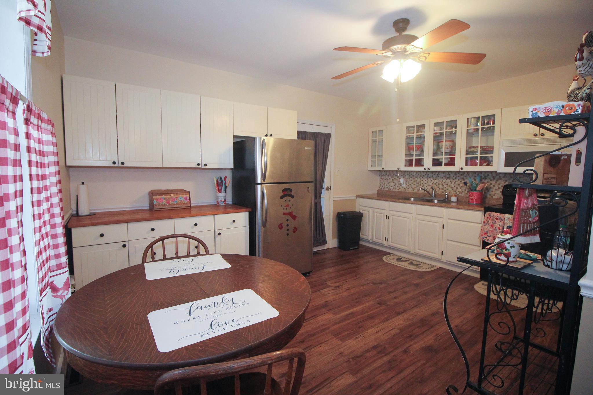 160 Funk Road Port Deposit, MD 21904 - Photo 49 of 51 a kitchen with stainless steel appliances granite countertop a sink a stove a refrigerator cabinets and dining table