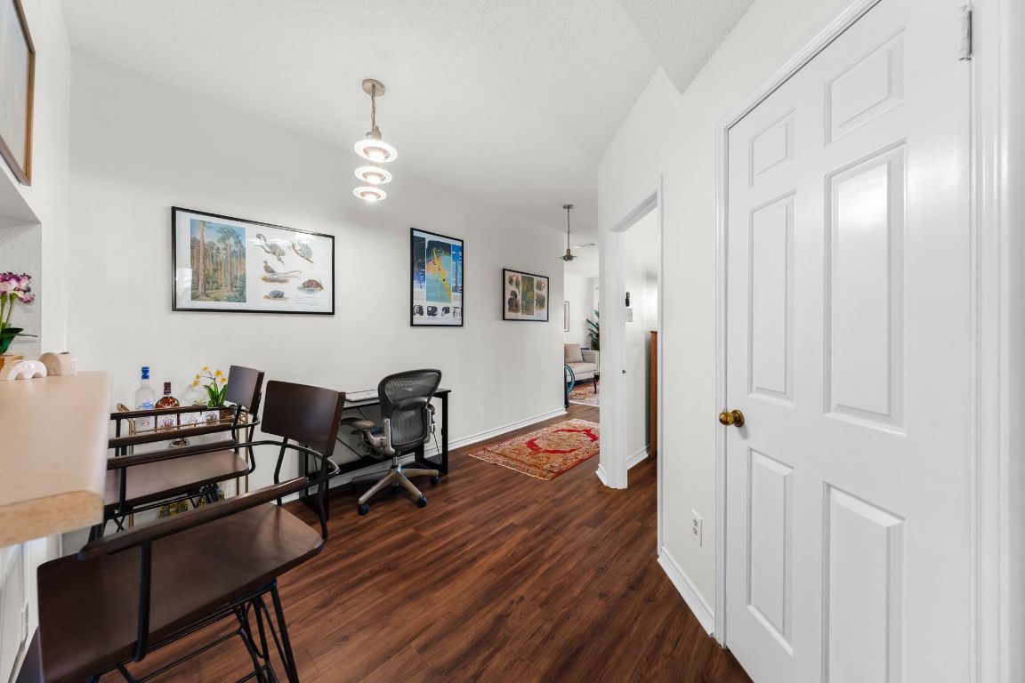 3001 Cedar Street, Unit 310 Austin, TX 78705 - Photo 15 of 27 a view of a workspace with furniture and wooden floor