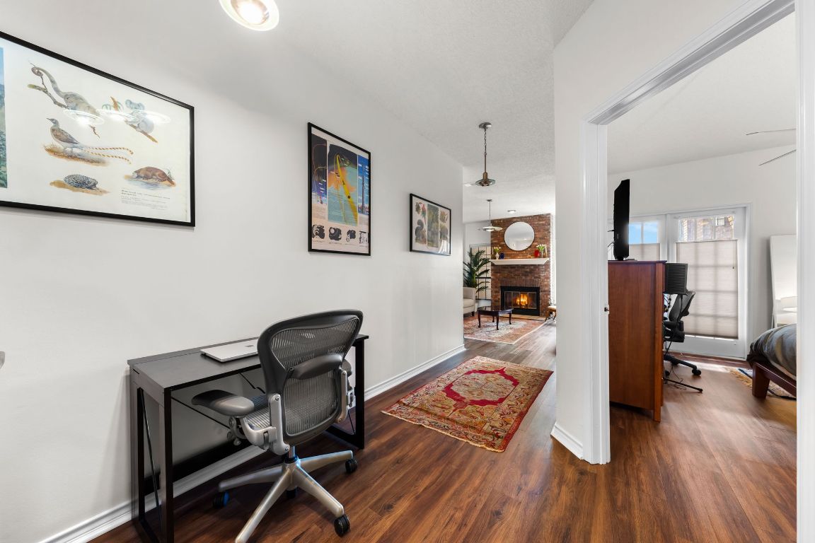 3001 Cedar Street, Unit 310 Austin, TX 78705 - Photo 16 of 27 a view of a workspace with furniture and wooden floor