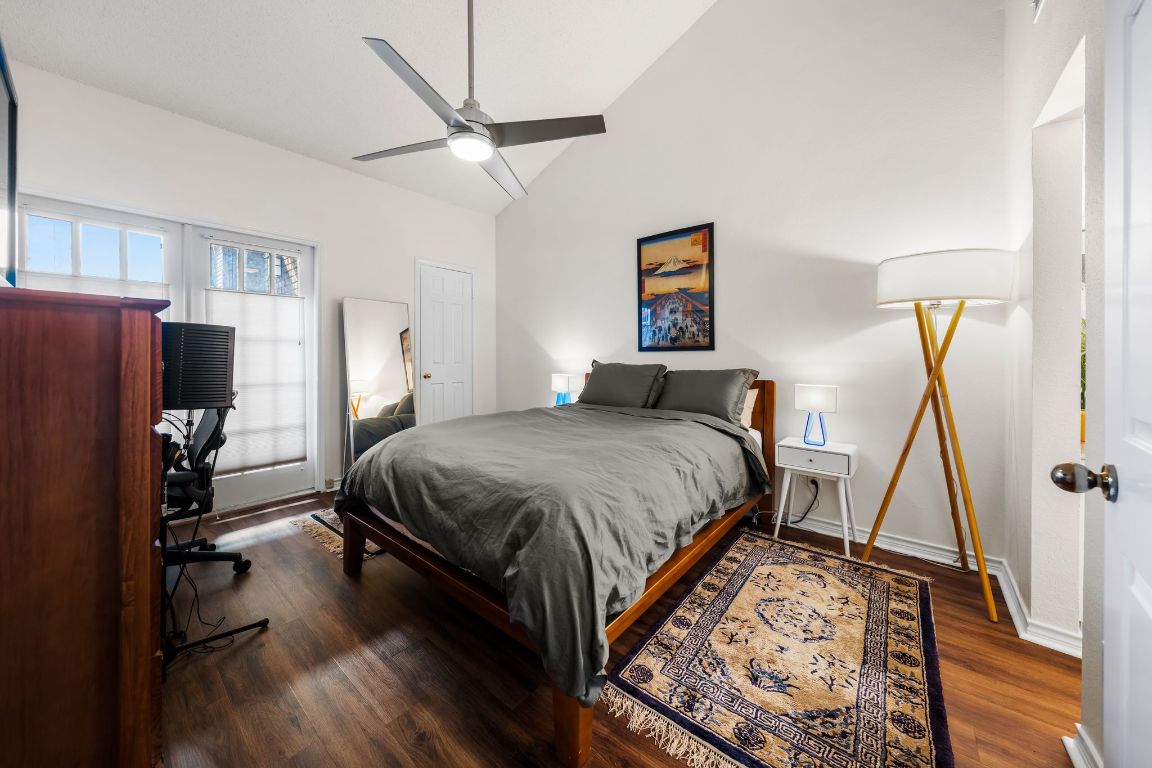 3001 Cedar Street, Unit 310 Austin, TX 78705 - Photo 17 of 27 a spacious bedroom with a bed and a flat screen tv
