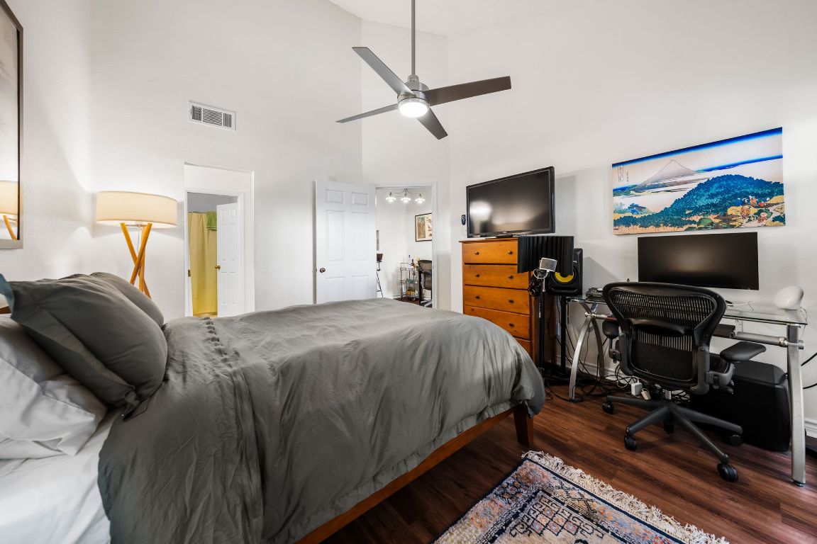 3001 Cedar Street, Unit 310 Austin, TX 78705 - Photo 18 of 27 a bed room with a bed and a flat screen tv