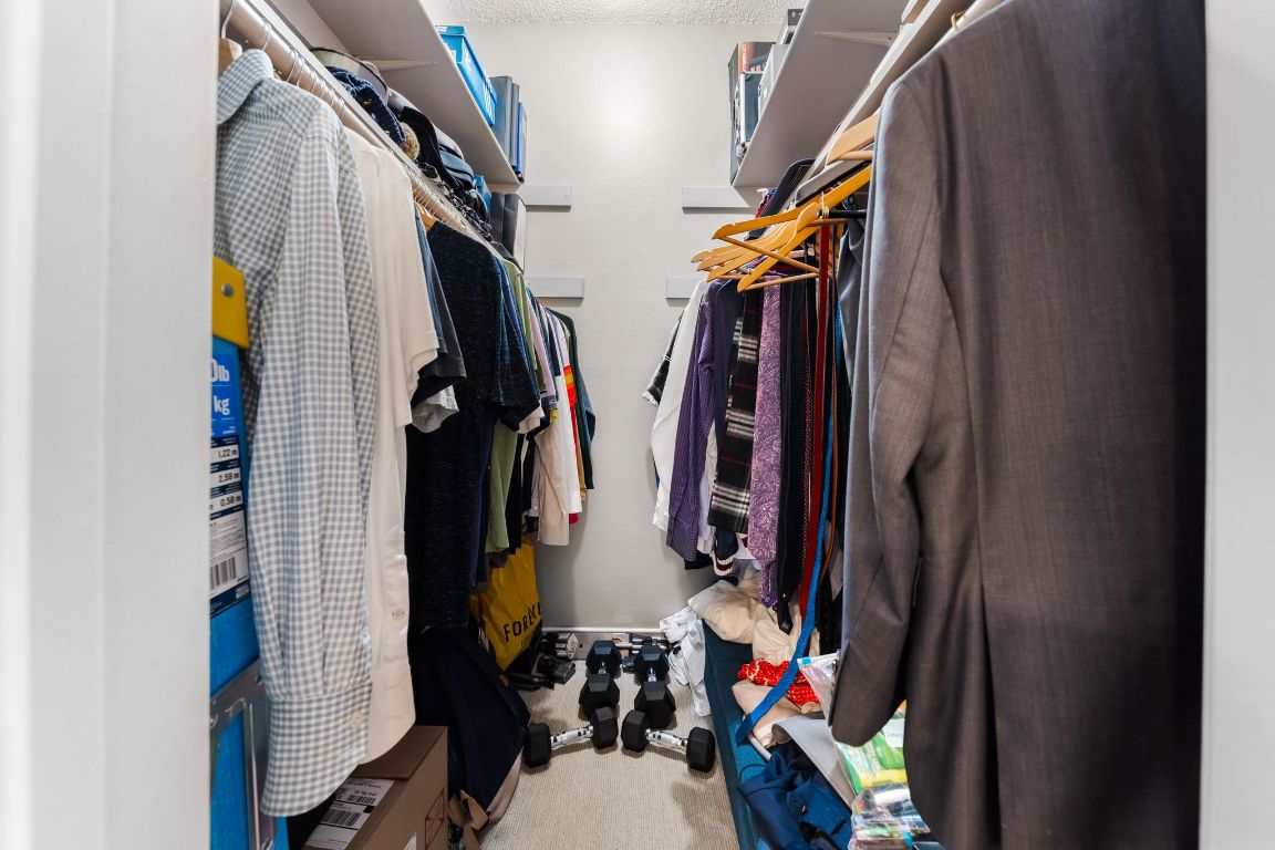 3001 Cedar Street, Unit 310 Austin, TX 78705 - Photo 22 of 27 a view of walk in closet with clothes and shoes