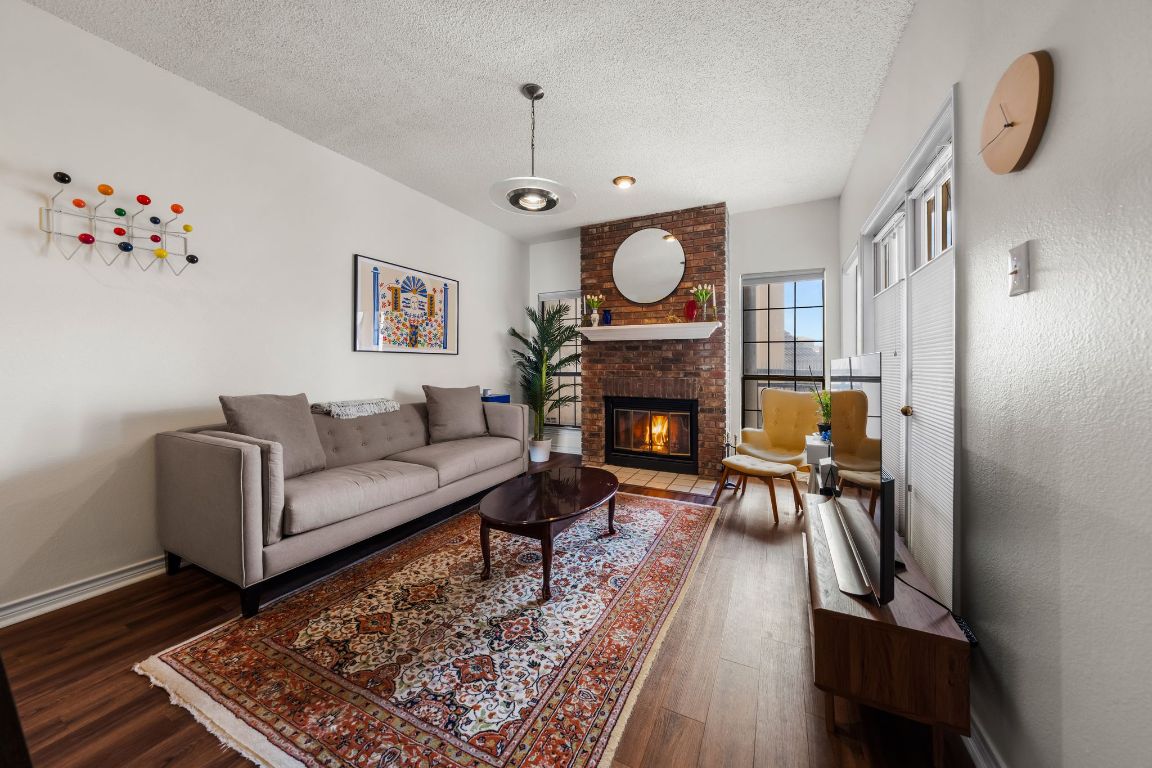 3001 Cedar Street, Unit 310 Austin, TX 78705 - Photo 3 of 27 a living room with furniture and a fireplace