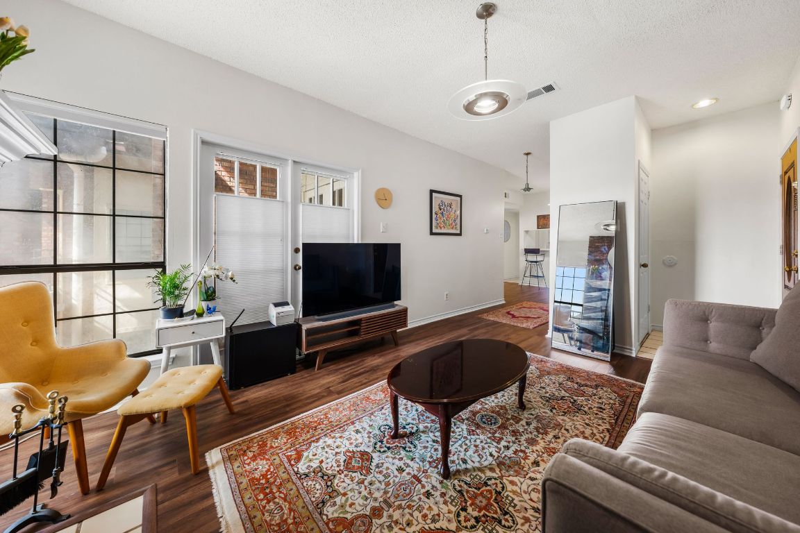 3001 Cedar Street, Unit 310 Austin, TX 78705 - Photo 4 of 27 a living room with furniture and a flat screen tv