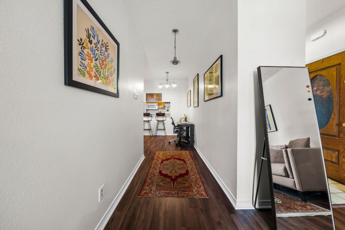 3001 Cedar Street, Unit 310 Austin, TX 78705 - Photo 5 of 27 a view of a hallway with wooden floor and stairs