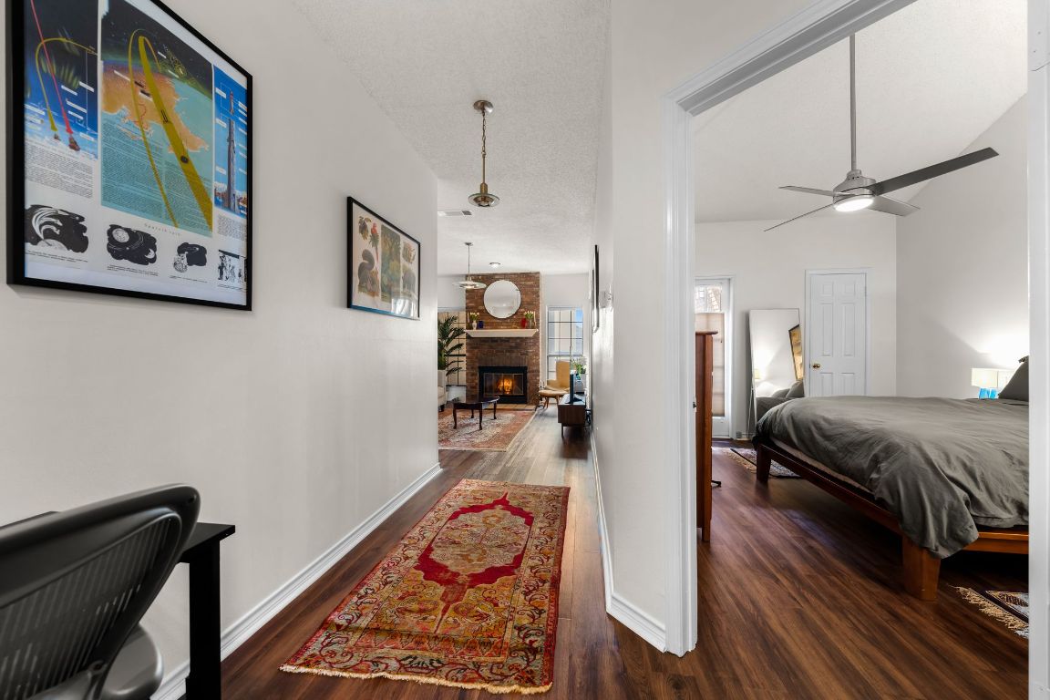 3001 Cedar Street, Unit 310 Austin, TX 78705 - Photo 6 of 27 a bed room with a bed and a painting on the wall