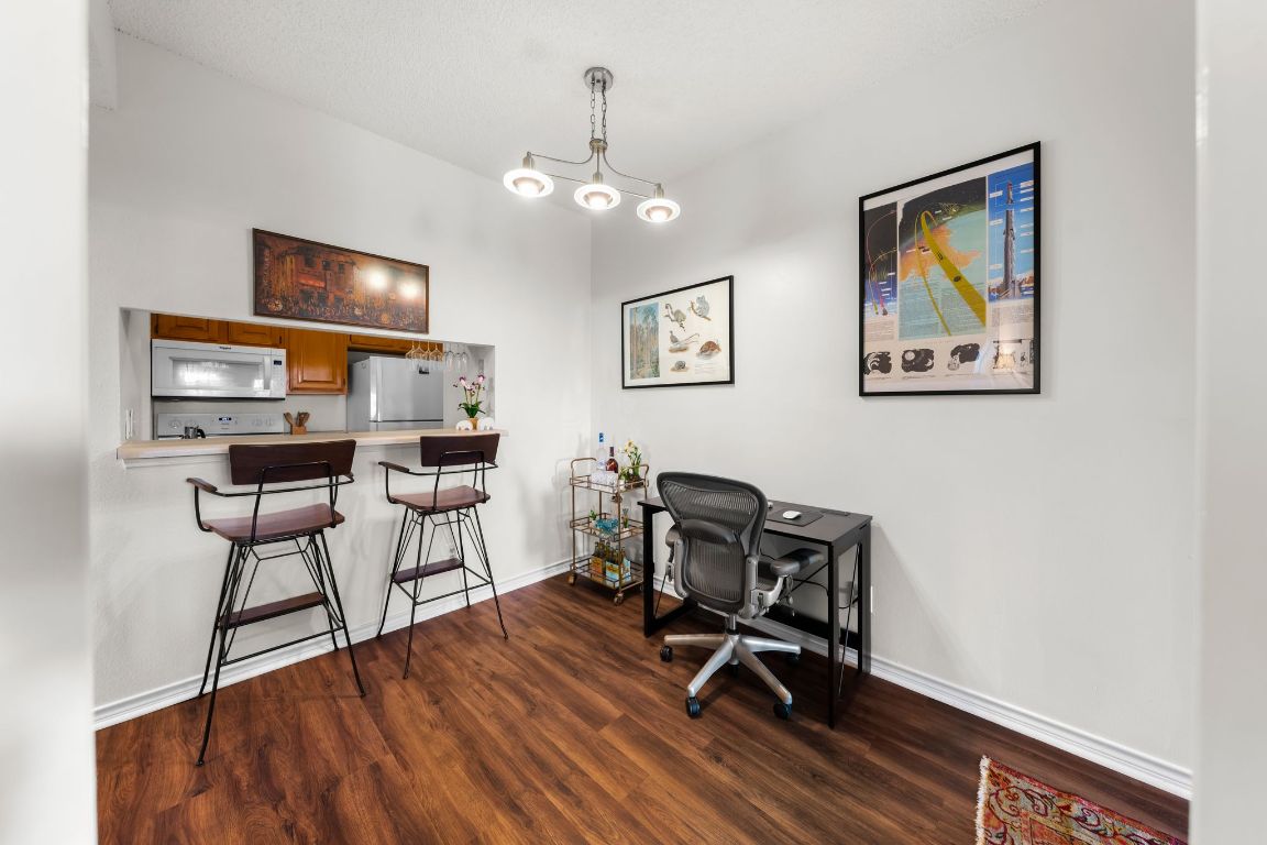 3001 Cedar Street, Unit 310 Austin, TX 78705 - Photo 7 of 27 a view of a workspace with furniture and a flat screen tv