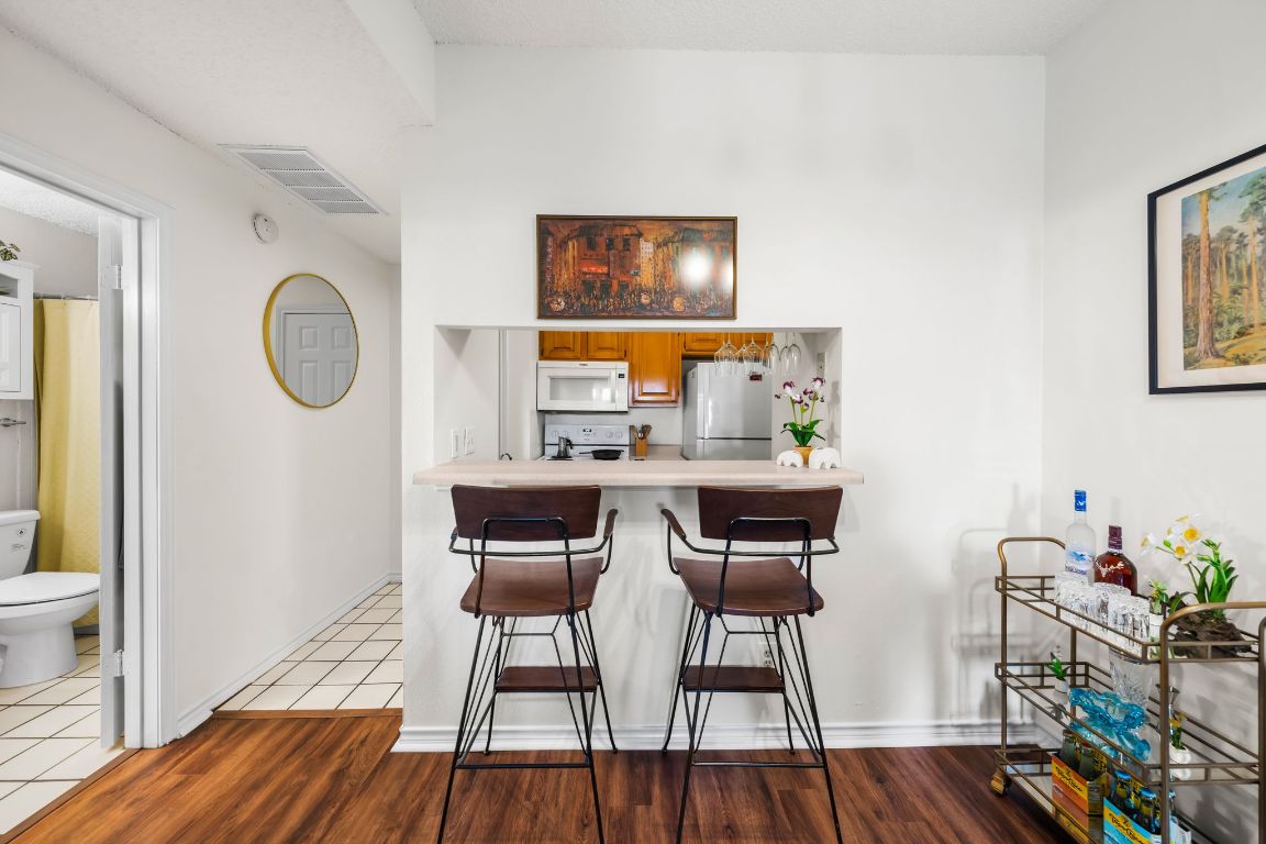 3001 Cedar Street, Unit 310 Austin, TX 78705 - Photo 8 of 27 a view of a dining room with furniture and wooden floor