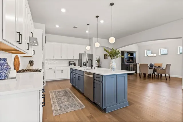 a large kitchen with lots of counter space and sink