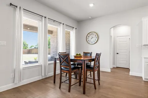 a view of a dining room with furniture and a large window