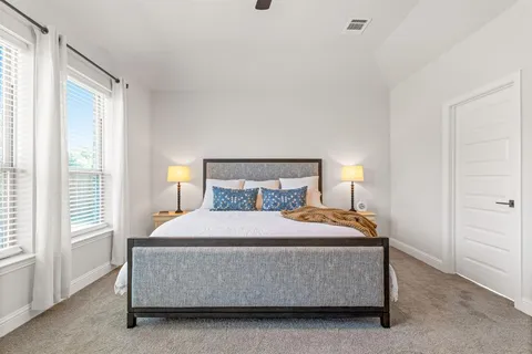 a bedroom with a bed and window