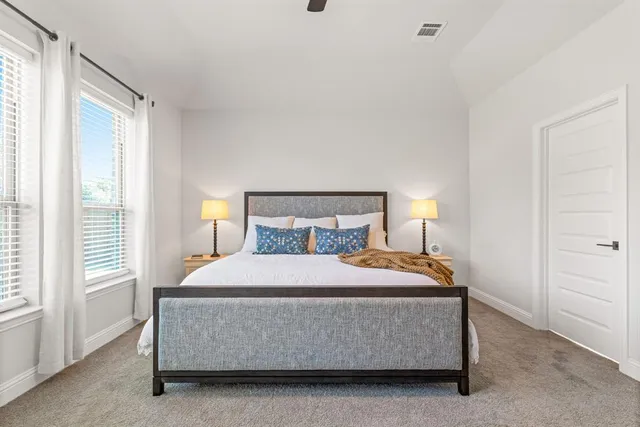 a bedroom with a bed and window