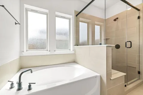 a bathroom with a tub and shower