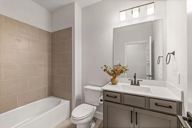 a bathroom with a sink mirror toilet and bathtub