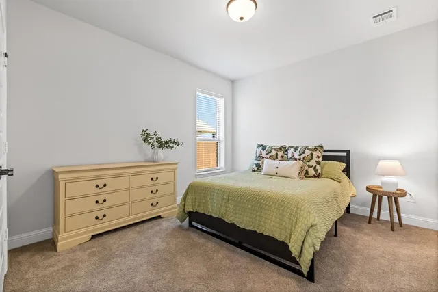 a bedroom with a bed and a dresser