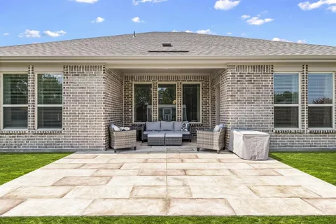 a view of a patio with a dining table and chairs