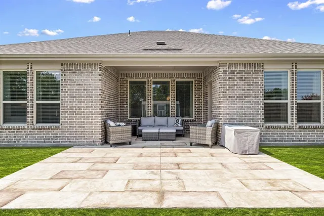 a view of a patio with a dining table and chairs