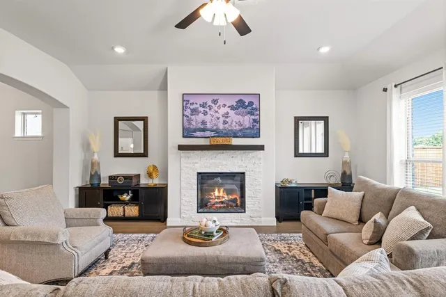 a living room with furniture and a fireplace