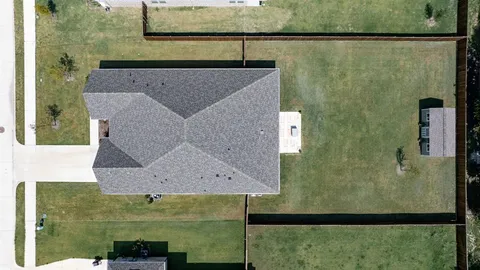 an aerial view of a house with a lake view