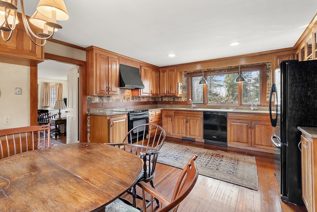 34 Miles River Road Hamilton, MA 01982 - Photo 19 of 42 a kitchen with kitchen island a large counter top space appliances and a window