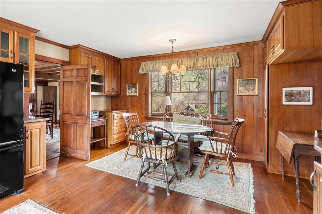 34 Miles River Road Hamilton, MA 01982 - Photo 20 of 42 a dining room with furniture a floor to ceiling window and wooden floor