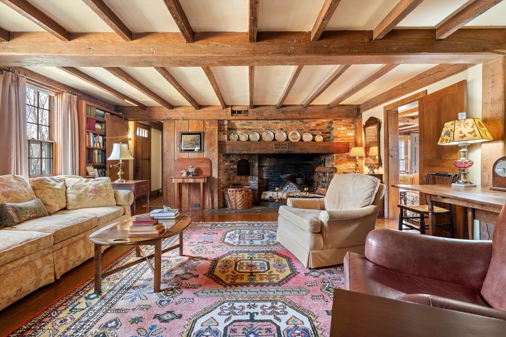 34 Miles River Road Hamilton, MA 01982 - Photo 6 of 42 a living room with furniture a fireplace and large windows