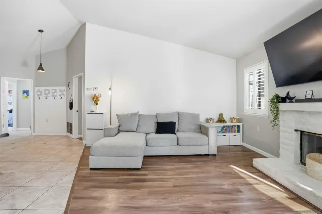 a living room with furniture a fireplace and a flat screen tv