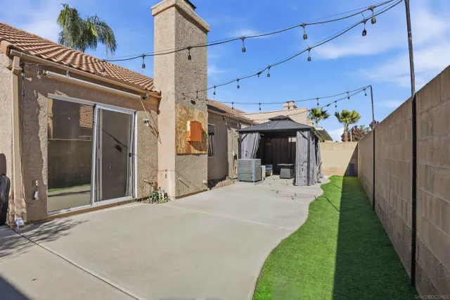 a view of a house with a porch and furniture