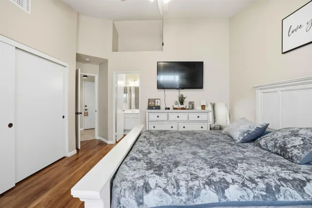 a living room with a bed and a flat screen tv