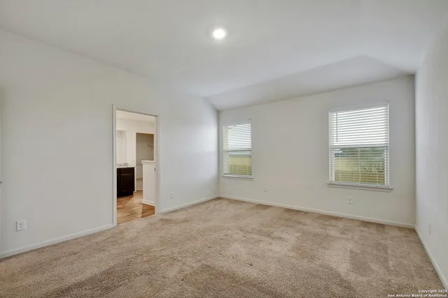 an empty room with windows and closet