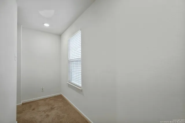a view of an empty room and a window
