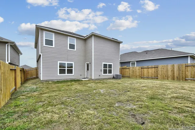 a view of a house with a backyard